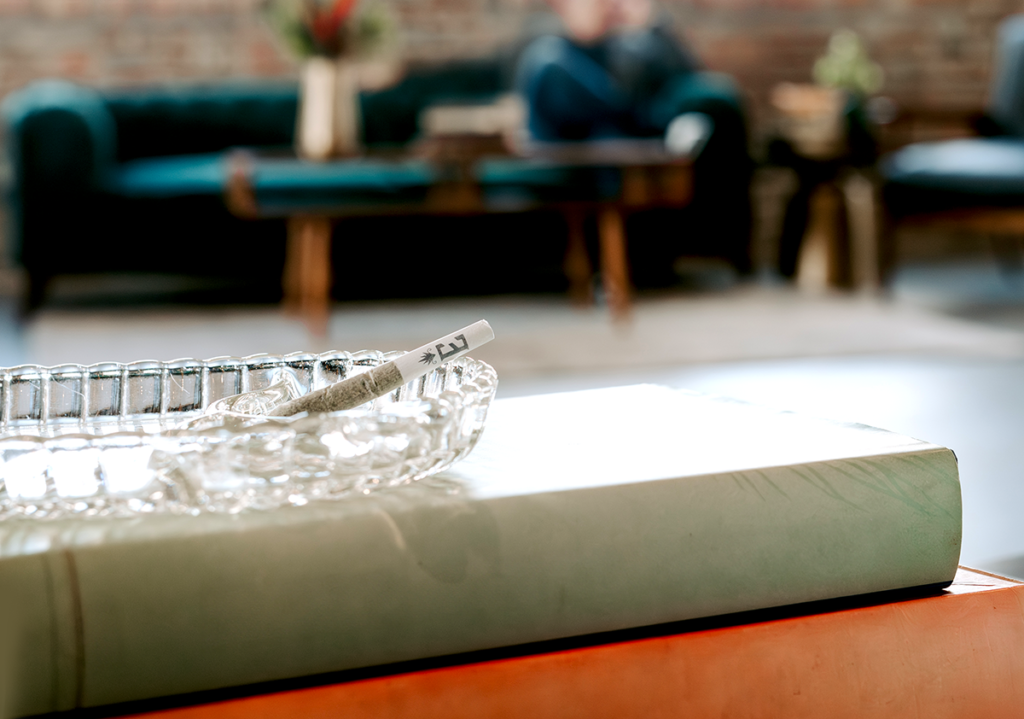 Elevate cannabis infused pre-roll on a stack of books